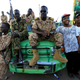 Sudanese boys pose for a photo with Sudanese military personnel, positioned near a bridge gate, during a sit-in protest outside the Defence Ministry in Khartoum, Sudan April 15, 2019.